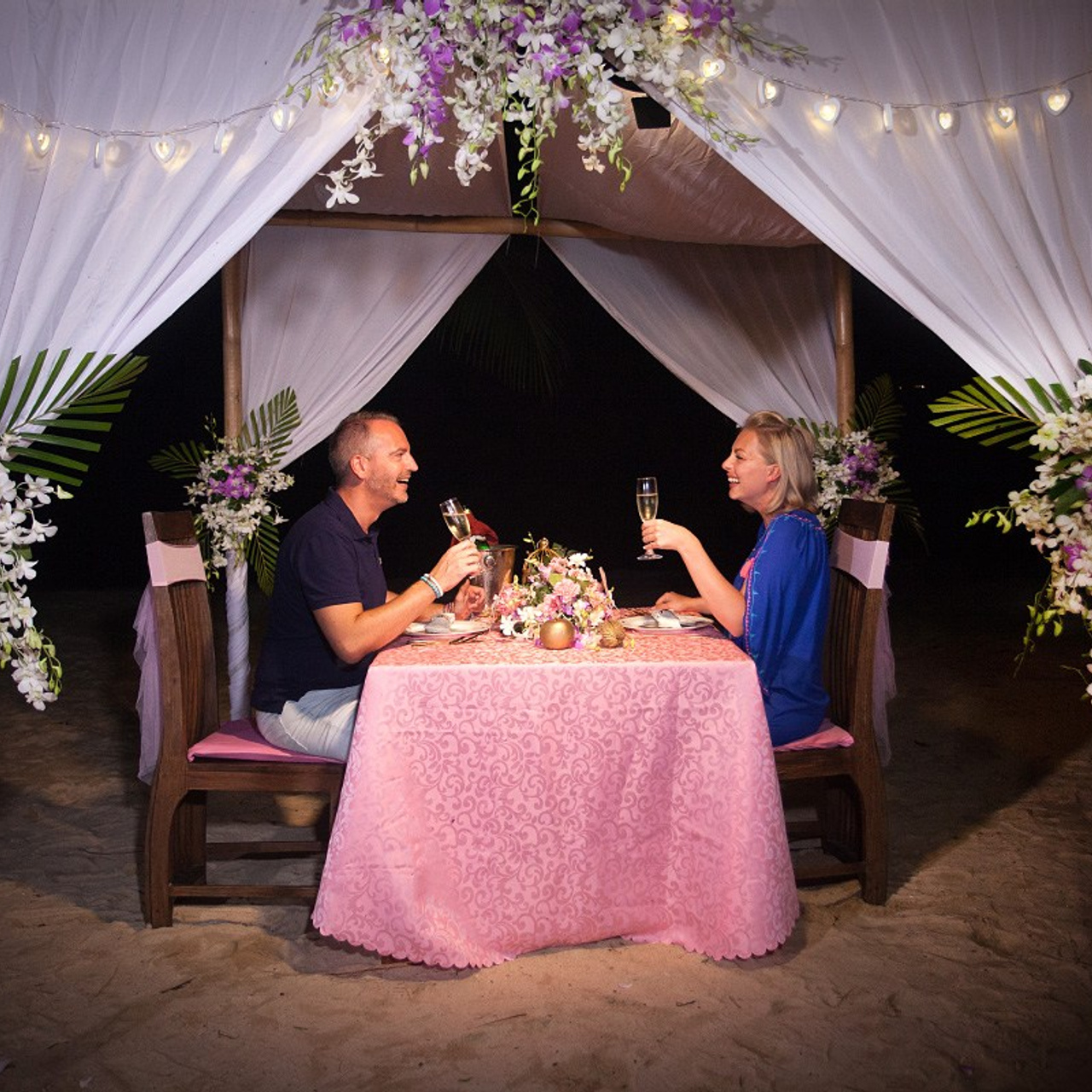 Luxury beach proposal in Koh Samui, Thailand. Private sunset setup with candles, flowers, and ocean view for an unforgettable engagement experience.