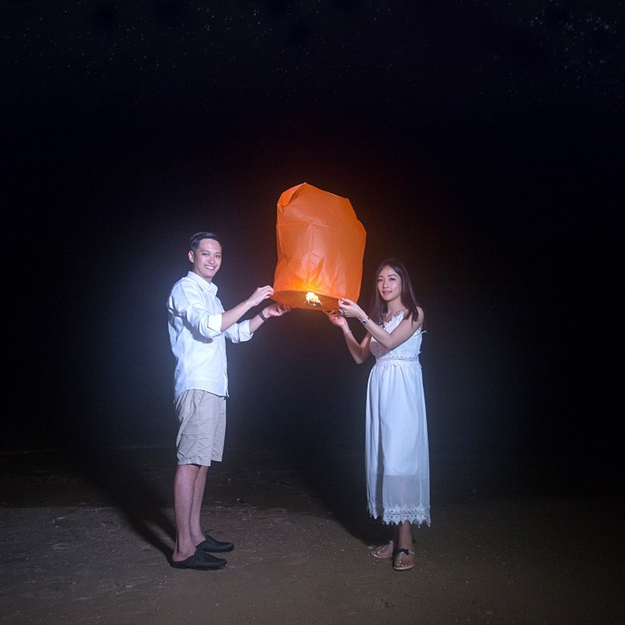 Romantic beach proposal setup in Koh Samui with candles and flower arch.