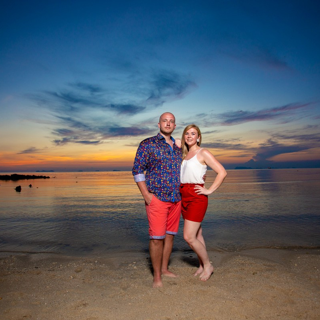 Romantic beach proposal setup in Koh Samui with candles and flower arch.