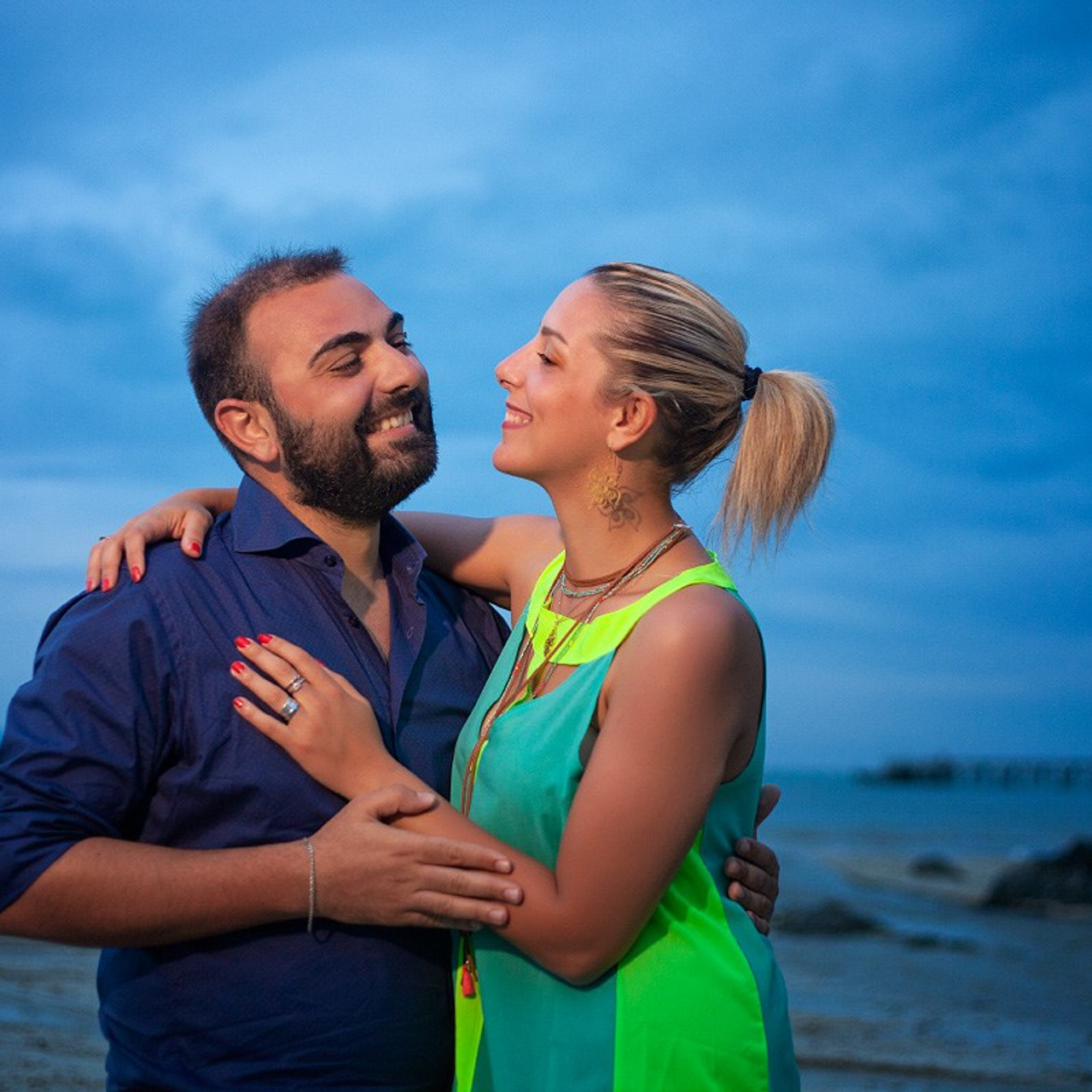 Romantic beach proposal setup in Koh Samui with candles and flower arch.