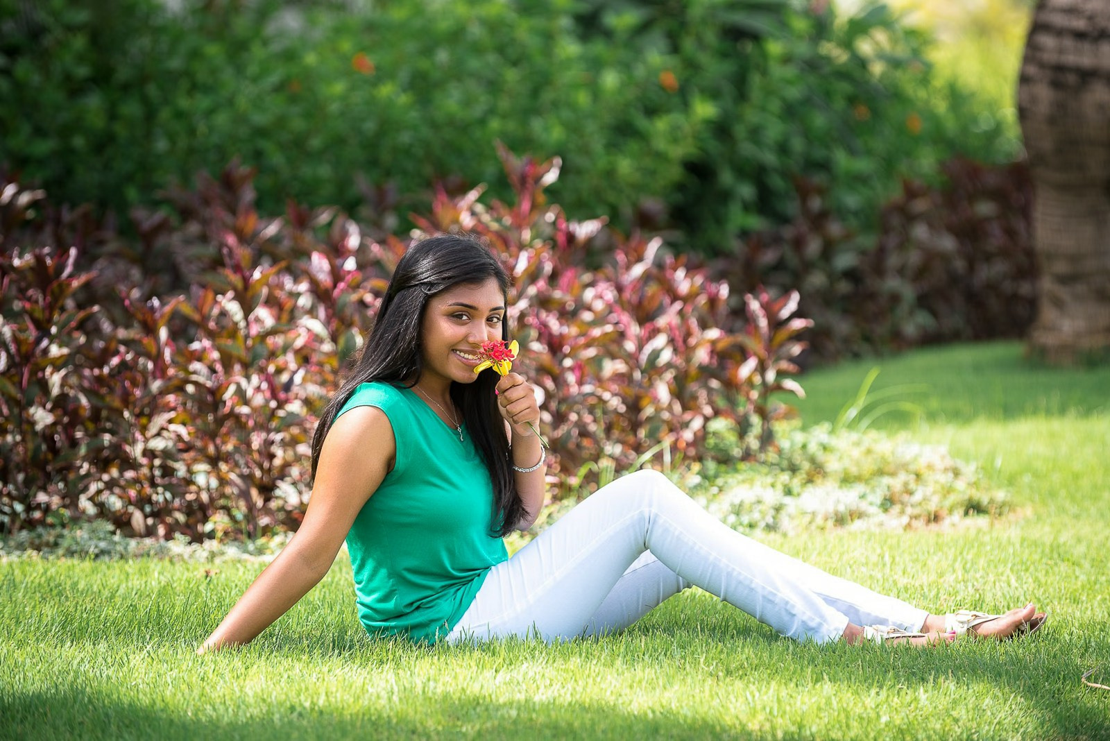 Woman sitting on the grass during a photoshoot at Hard Rock Punta Cana