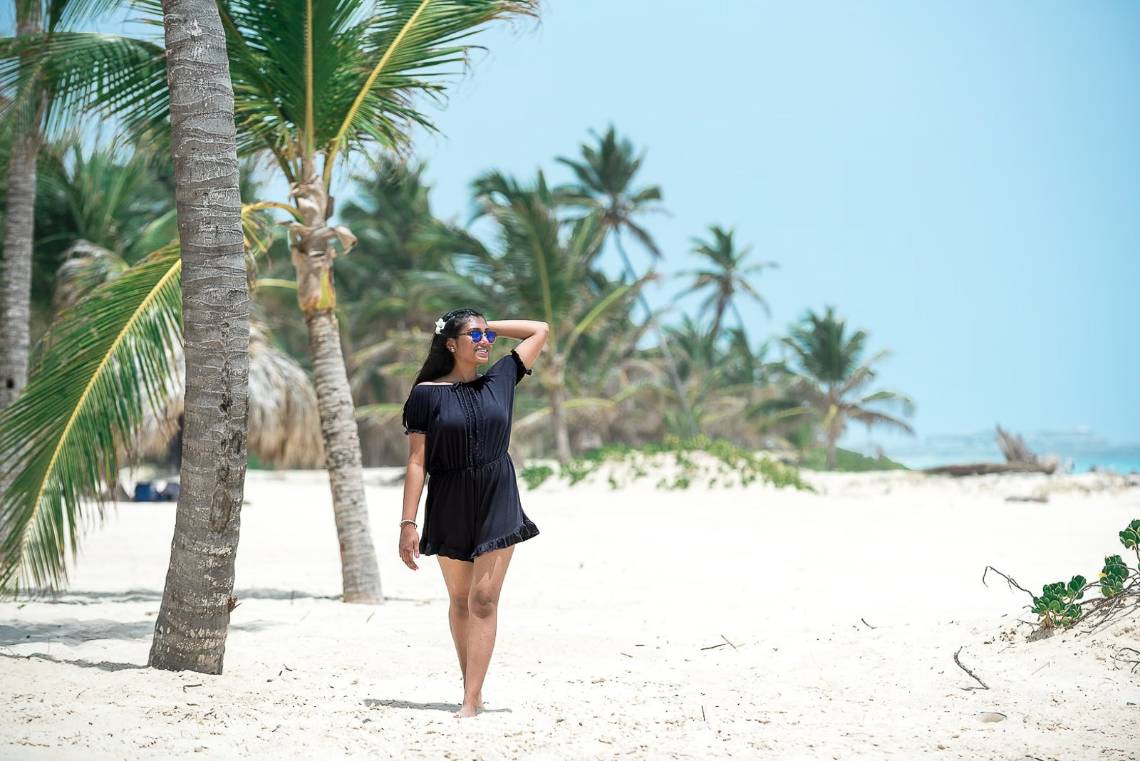 Indian woman walking along a tropical beach during a photoshoot in Punta Cana