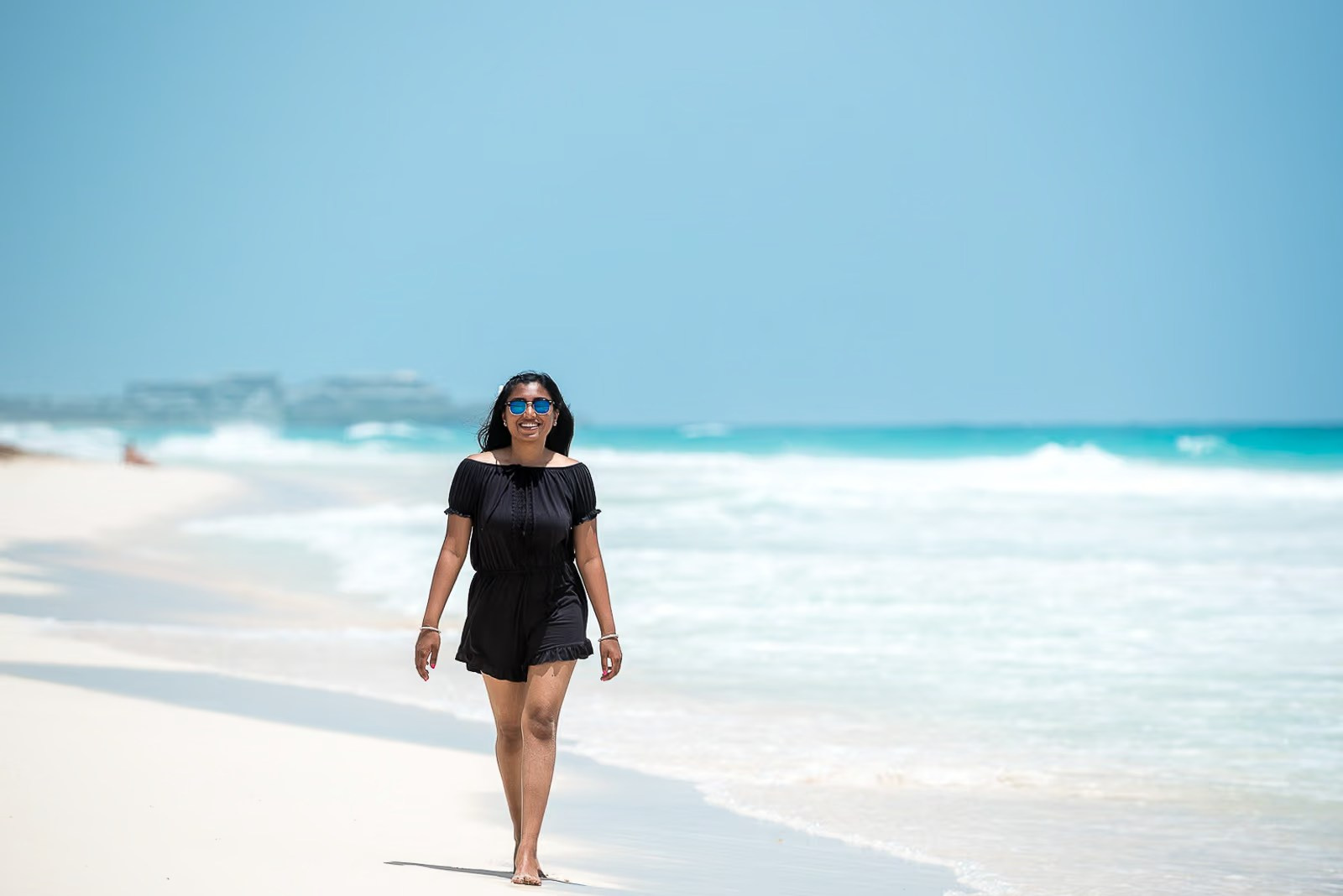 Portrait of an Indian woman with a flower and the Caribbean Sea in the background in Punta Cana