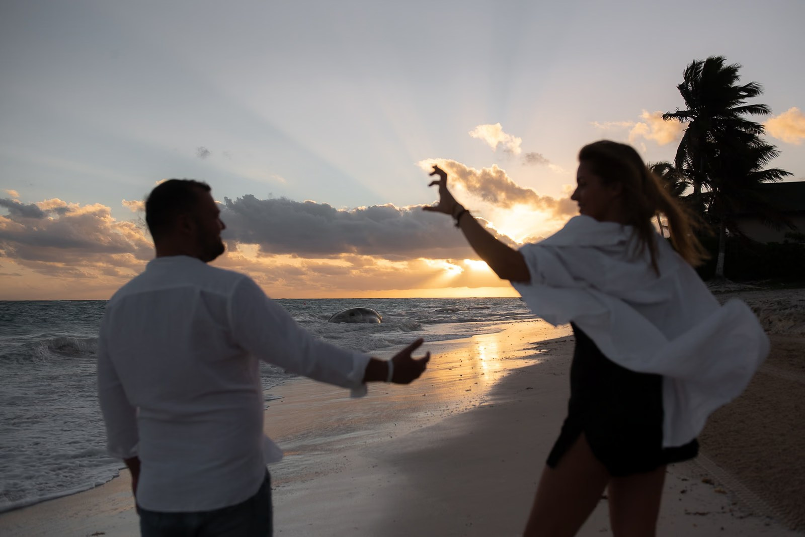 Boyfriend and girlfriend having fun on Bavaro Beach at sunrise