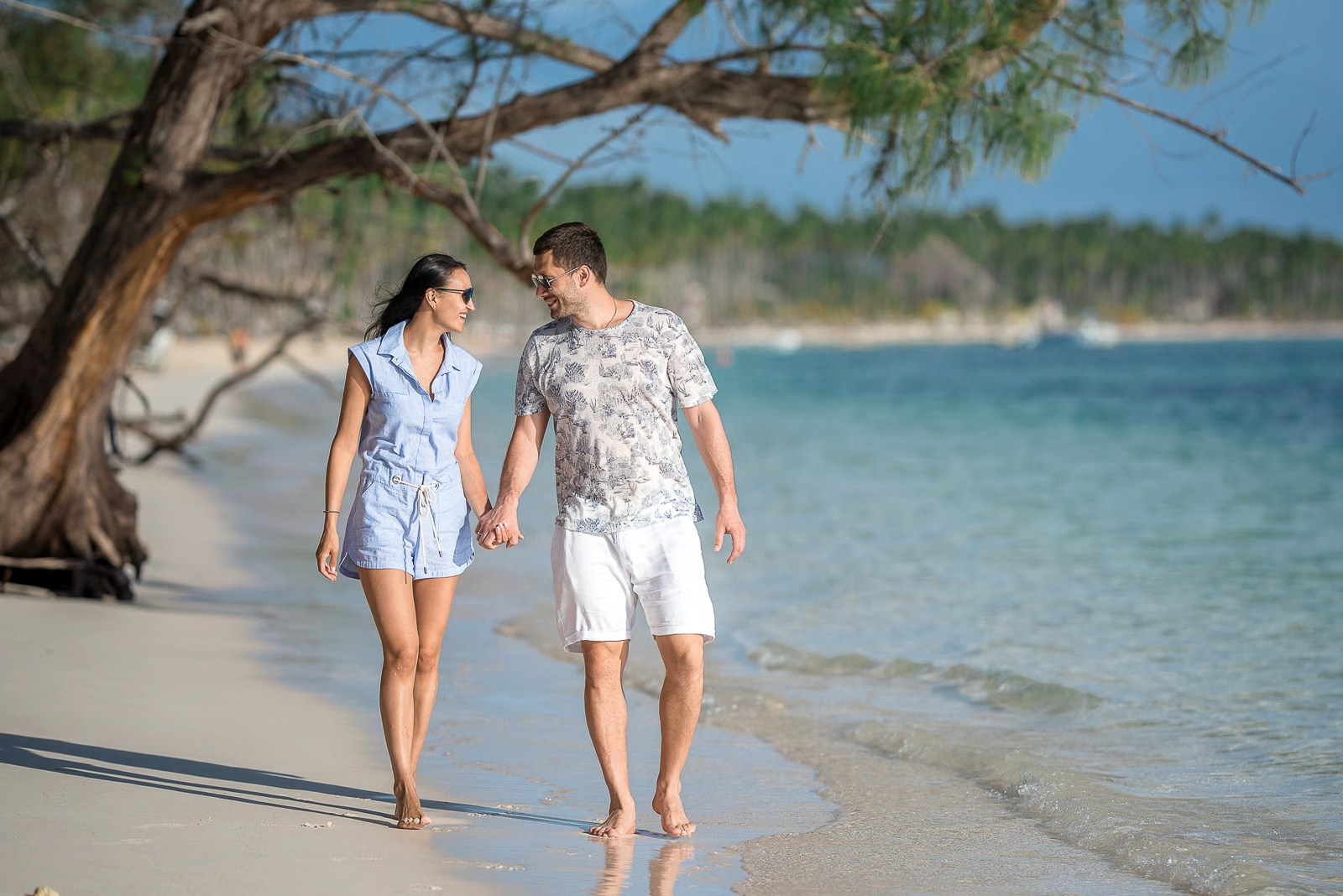 Couple walking along Bavaro Beach during a photoshoot