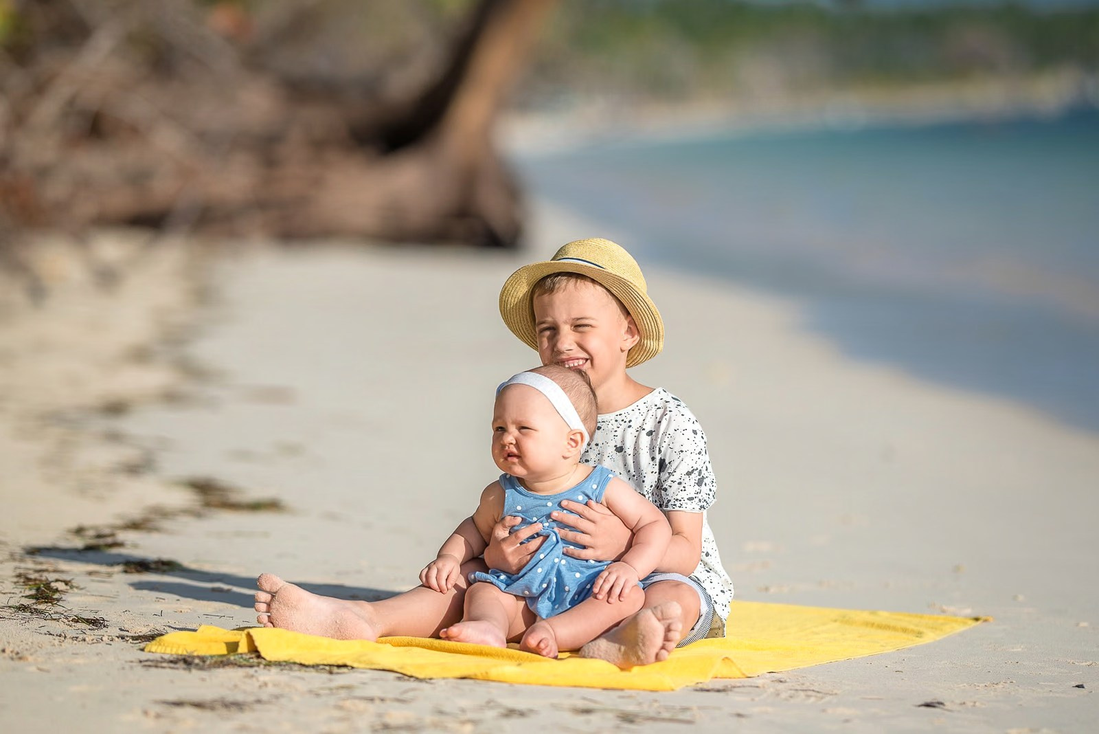 Kids sitting on Bavaro Beach and posing for a family photoshoot