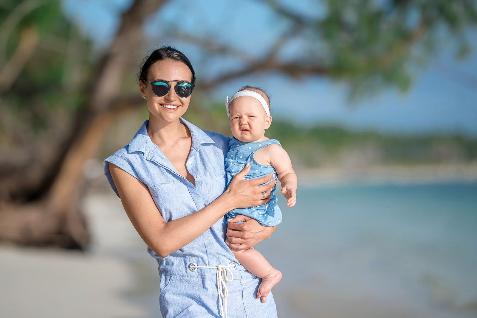 Mother and daughter smiling and posing during a family photoshoot
