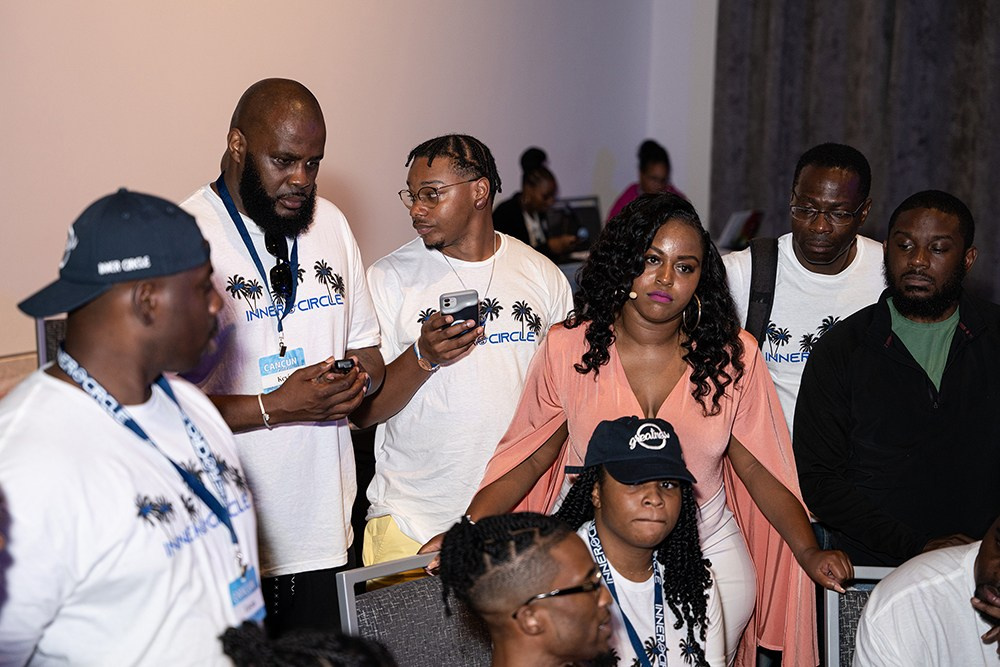 Group of participants discussing event highlights in casual conversation.