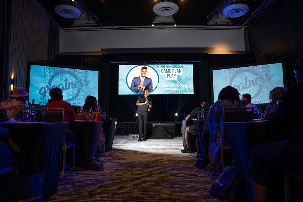 Presenter walking on stage while listeners follow every word.