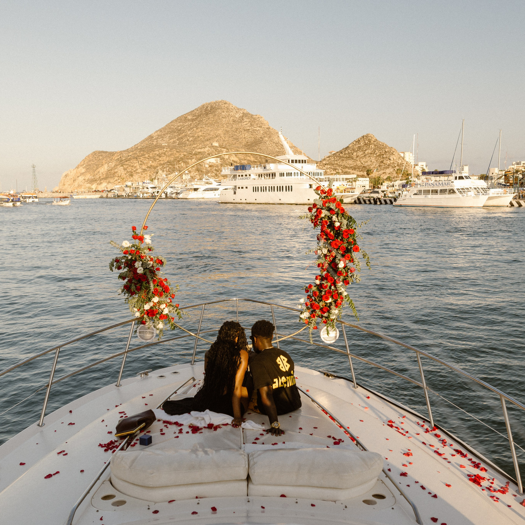 couple on a yacht, with a floral design , after proposal surprise at marina cabo san lucas