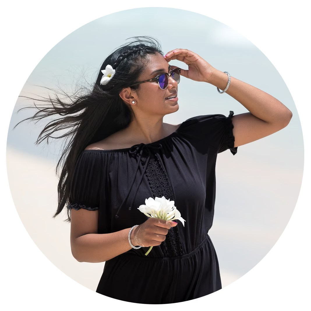 Portrait of an Indian woman with a flower and the Caribbean Sea in the background in Punta Cana