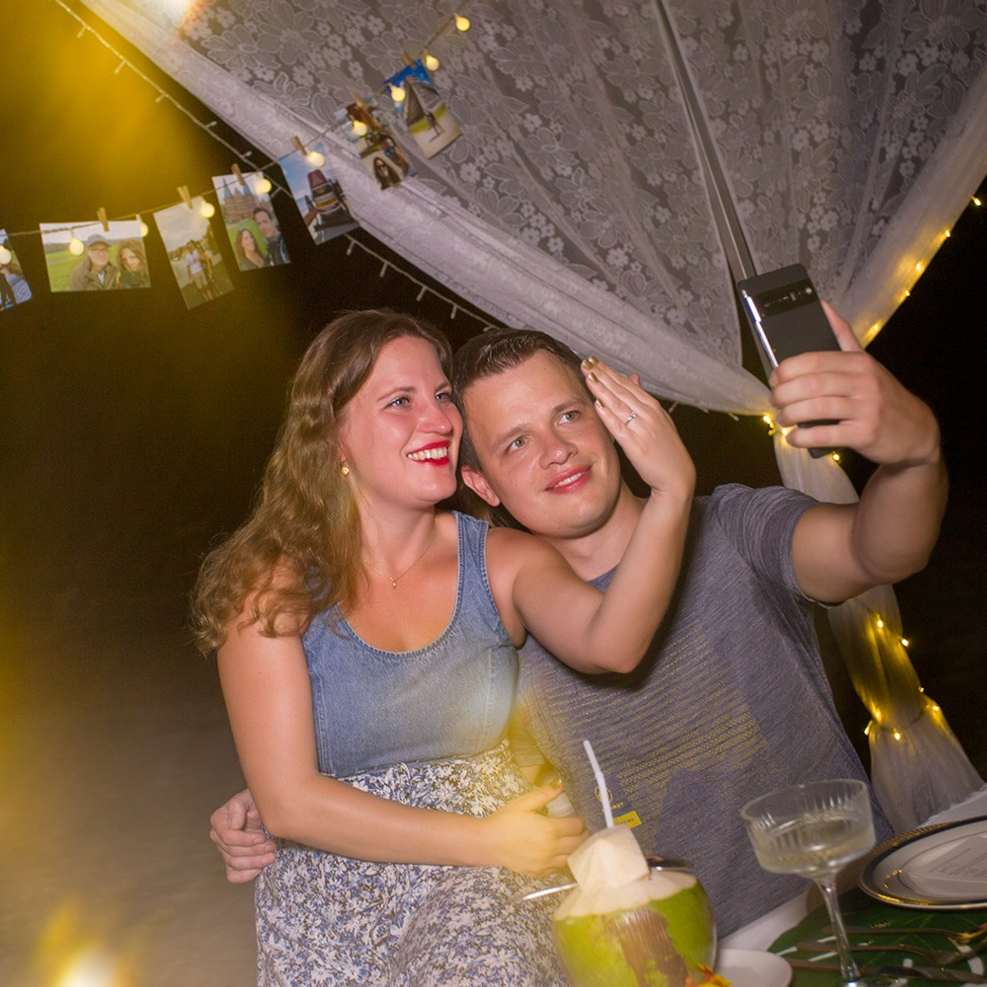 Romantic beach proposal setup in Koh Samui with candles and flower arch.
