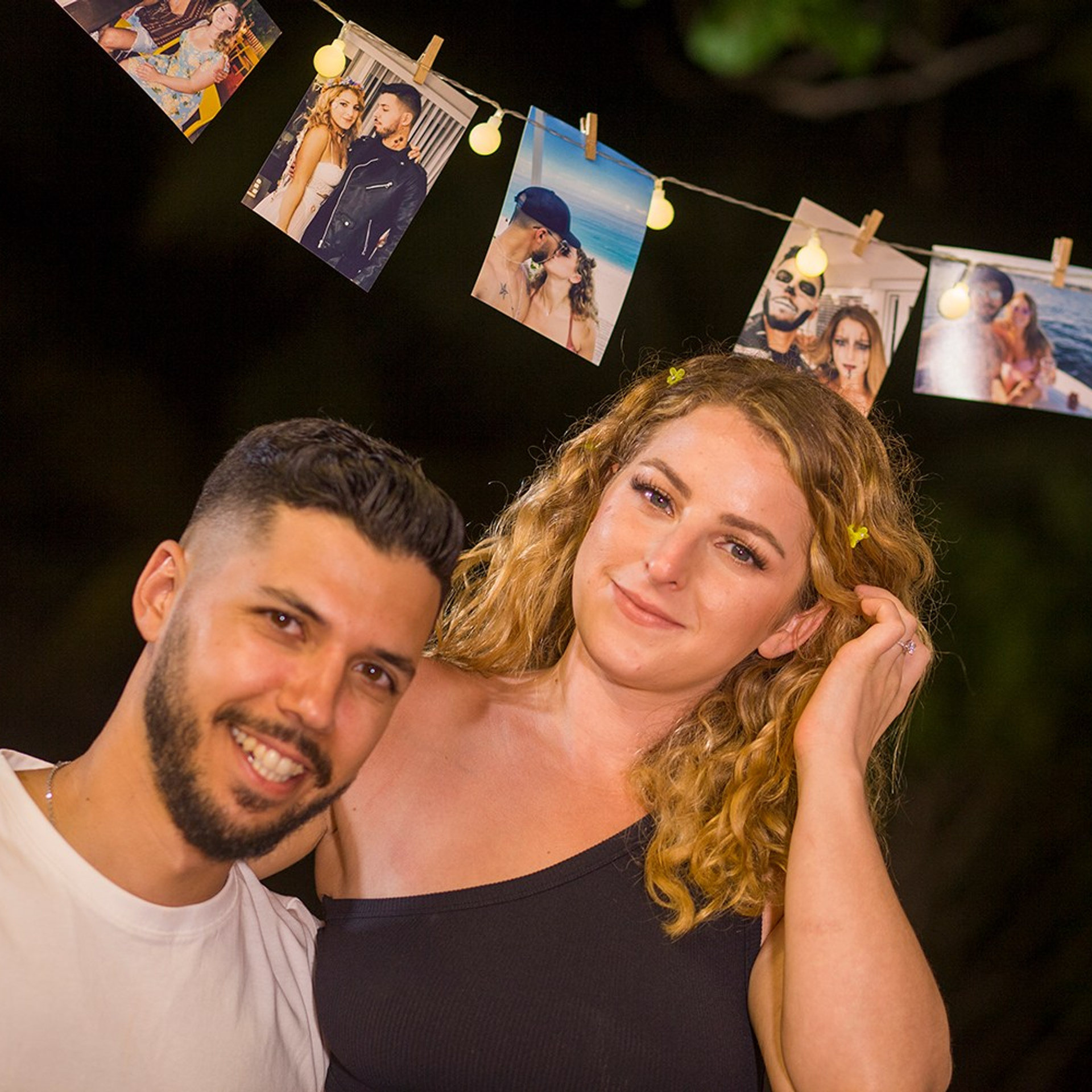 Romantic beach proposal setup in Koh Samui with candles and flower arch.