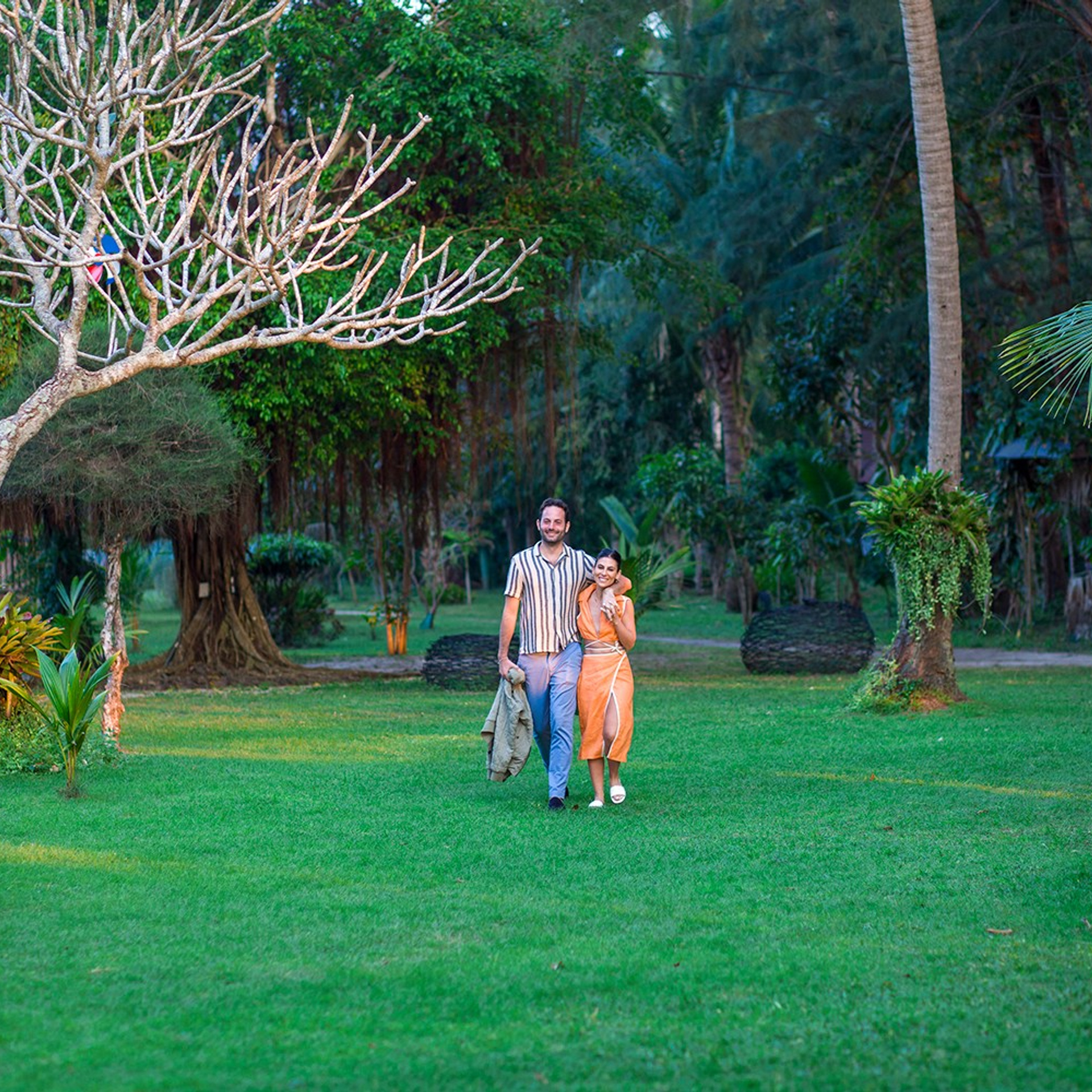 Romantic beach proposal setup in Koh Samui with candles and flower arch.