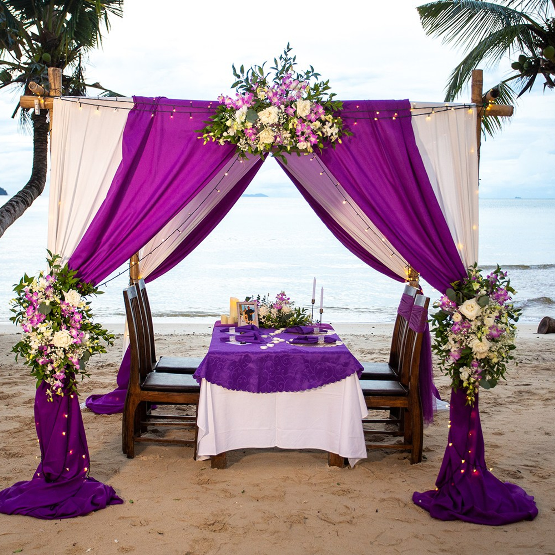 Luxury beach proposal in Koh Samui, Thailand. Private sunset setup with candles, flowers, and ocean view for an unforgettable engagement experience.