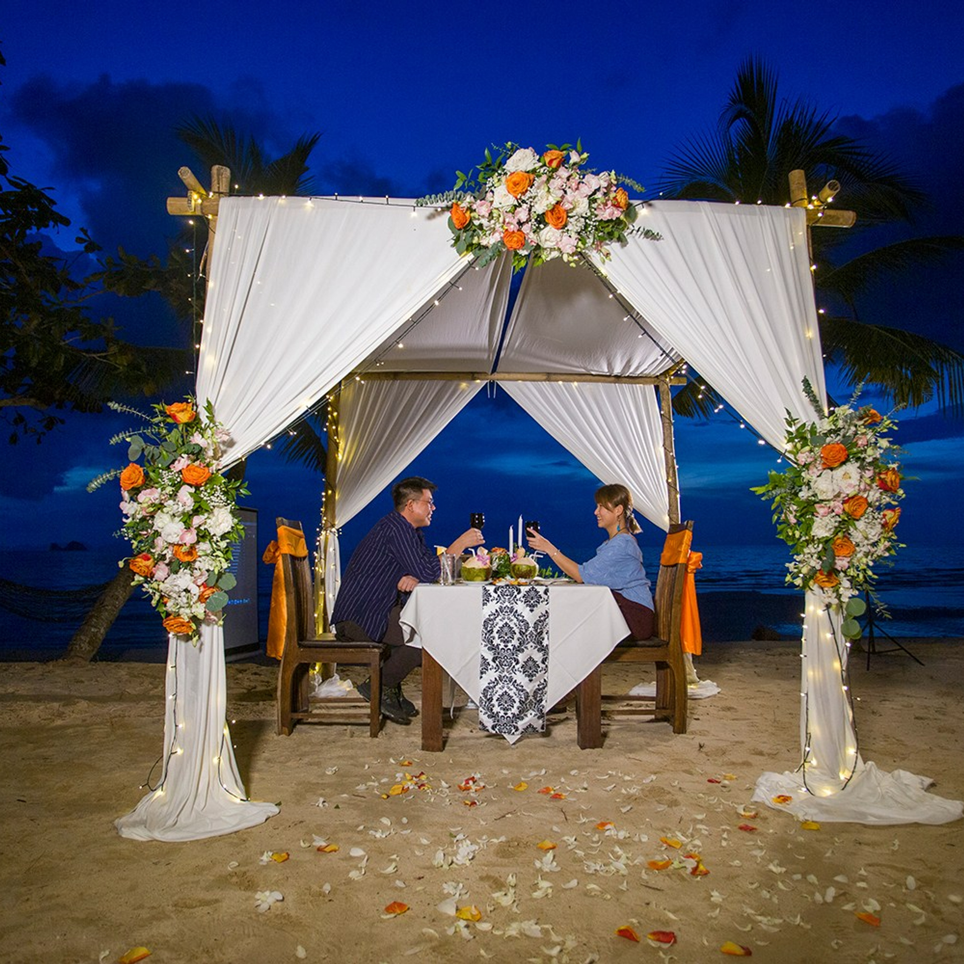 Luxury beach proposal in Koh Samui, Thailand. Private sunset setup with candles, flowers, and ocean view for an unforgettable engagement experience.