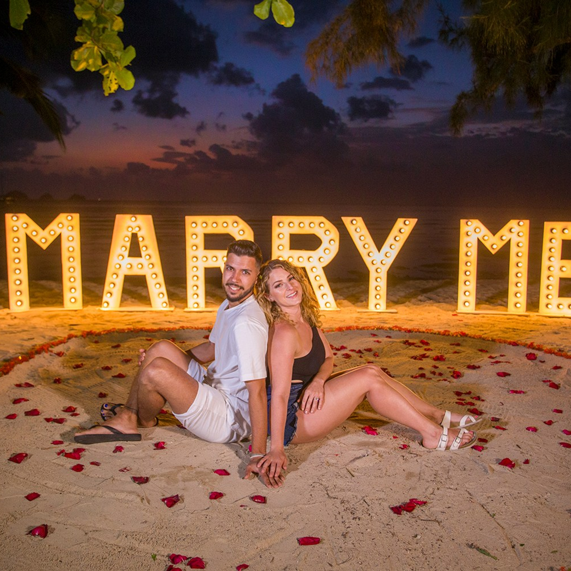 Luxury beach proposal in Koh Samui, Thailand. Private sunset setup with candles, flowers, and ocean view for an unforgettable engagement experience.