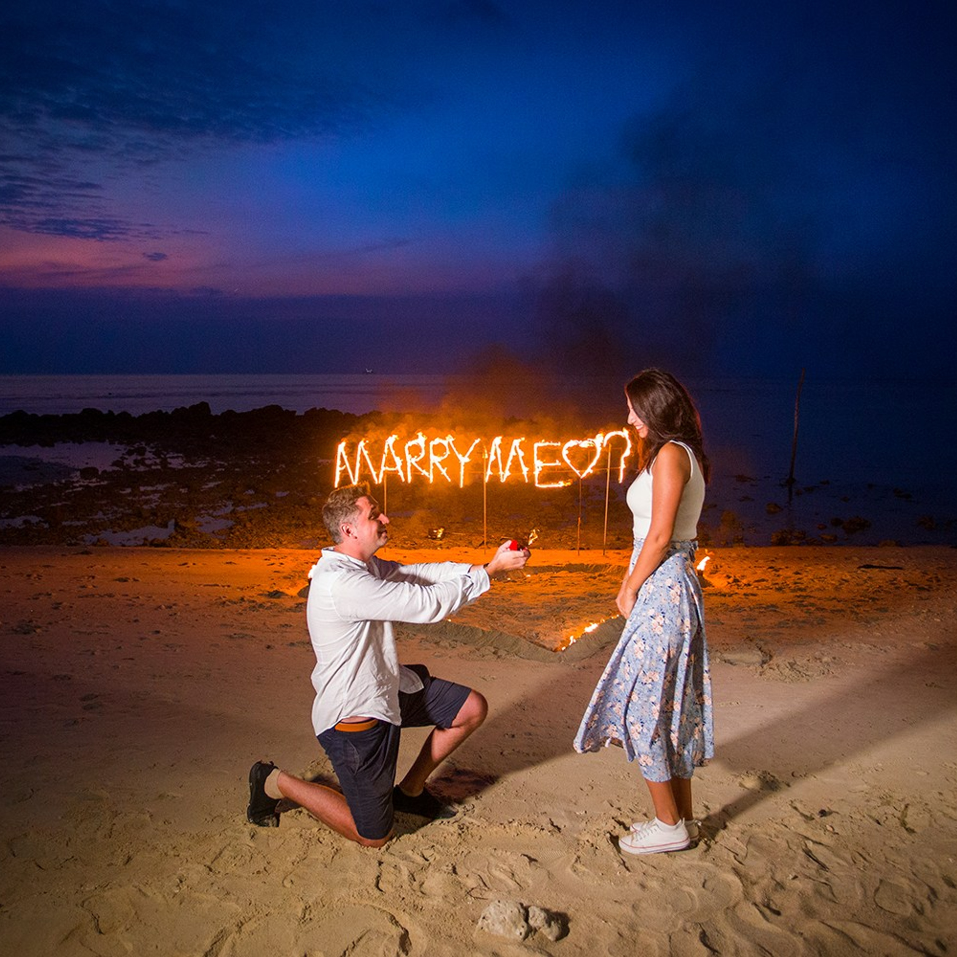 Luxury beach proposal in Koh Samui, Thailand. Private sunset setup with candles, flowers, and ocean view for an unforgettable engagement experience.
