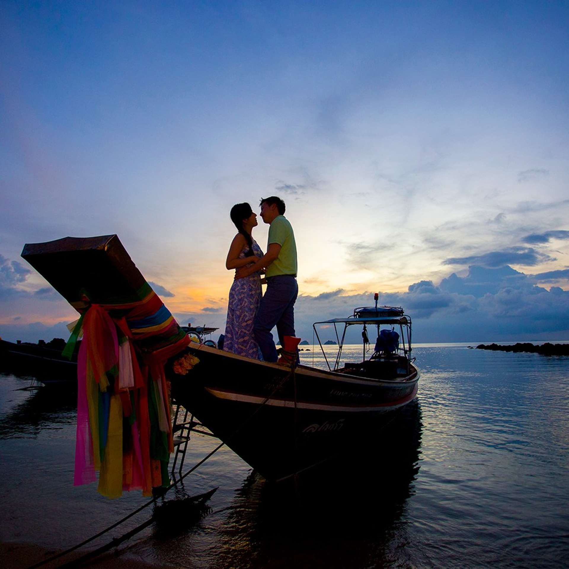 Romantic beach proposal setup in Koh Samui with candles and flower arch.