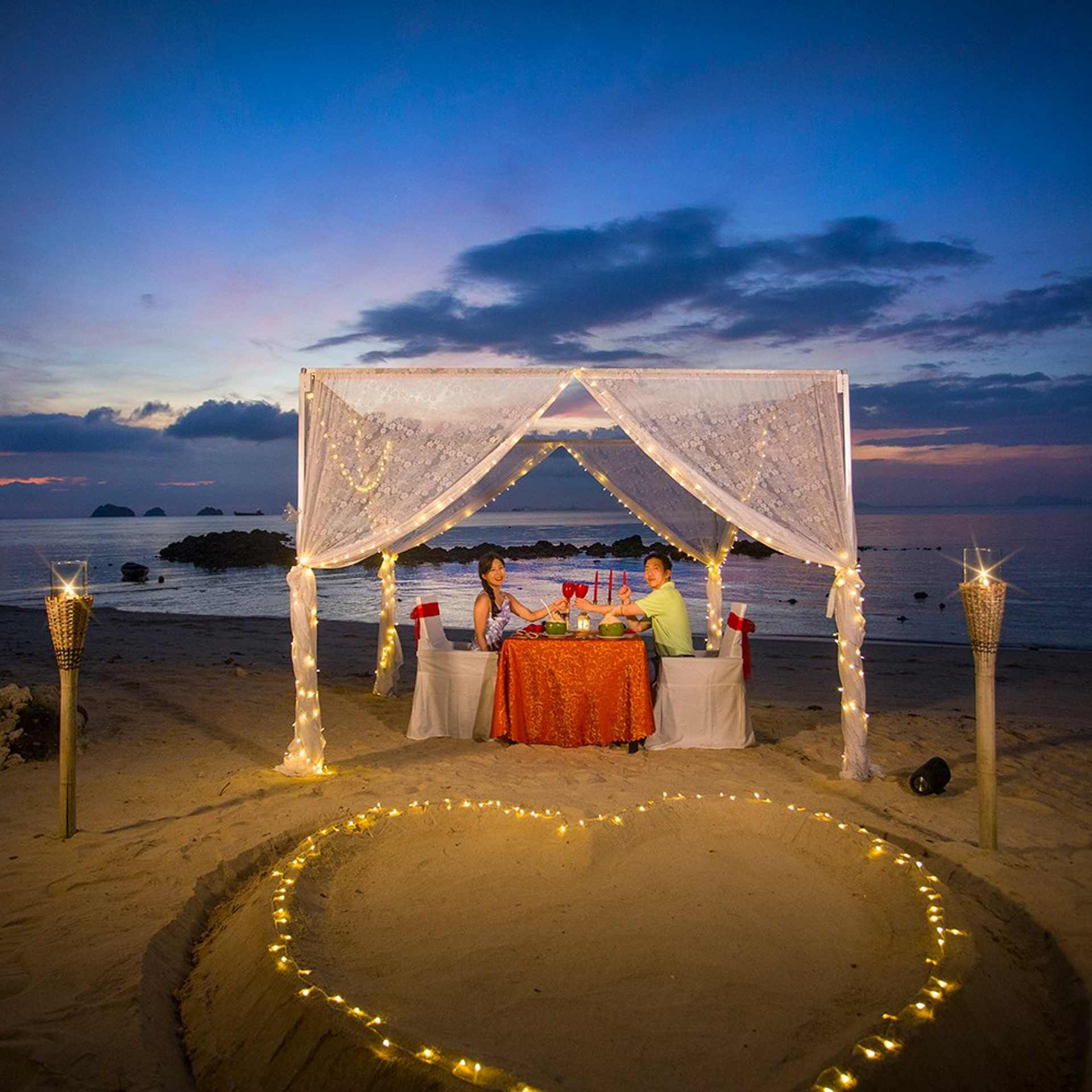 Luxury beach proposal in Koh Samui, Thailand. Private sunset setup with candles, flowers, and ocean view for an unforgettable engagement experience.