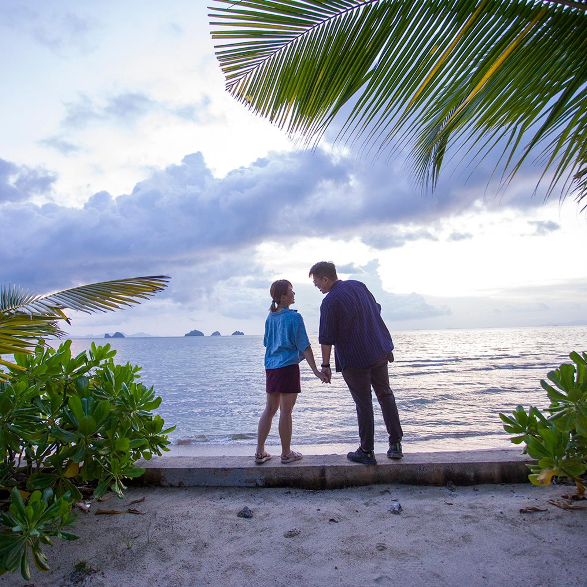 Romantic beach proposal setup in Koh Samui with candles and flower arch.