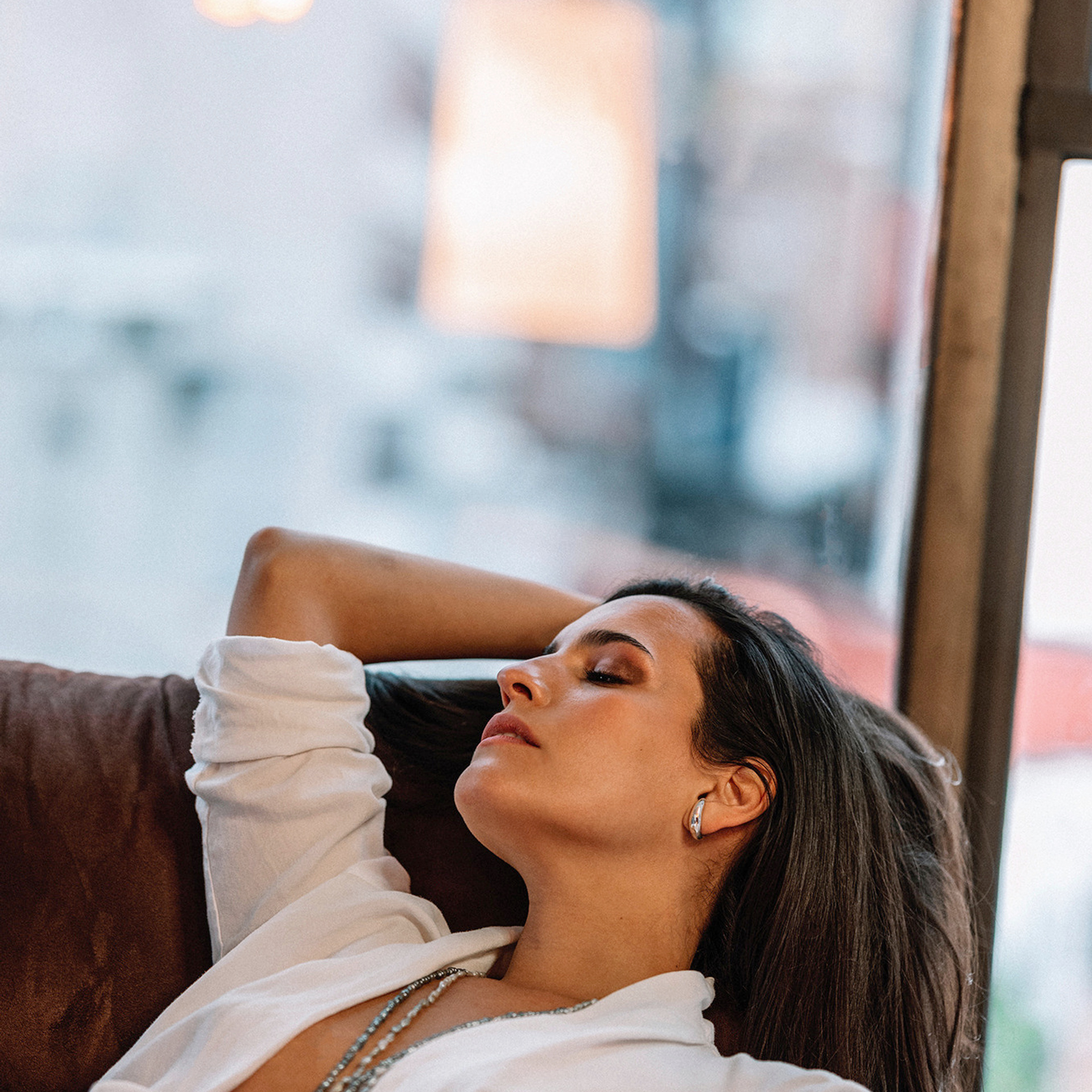 Natural portrait of woman resting by window - professional photo session Mexico City