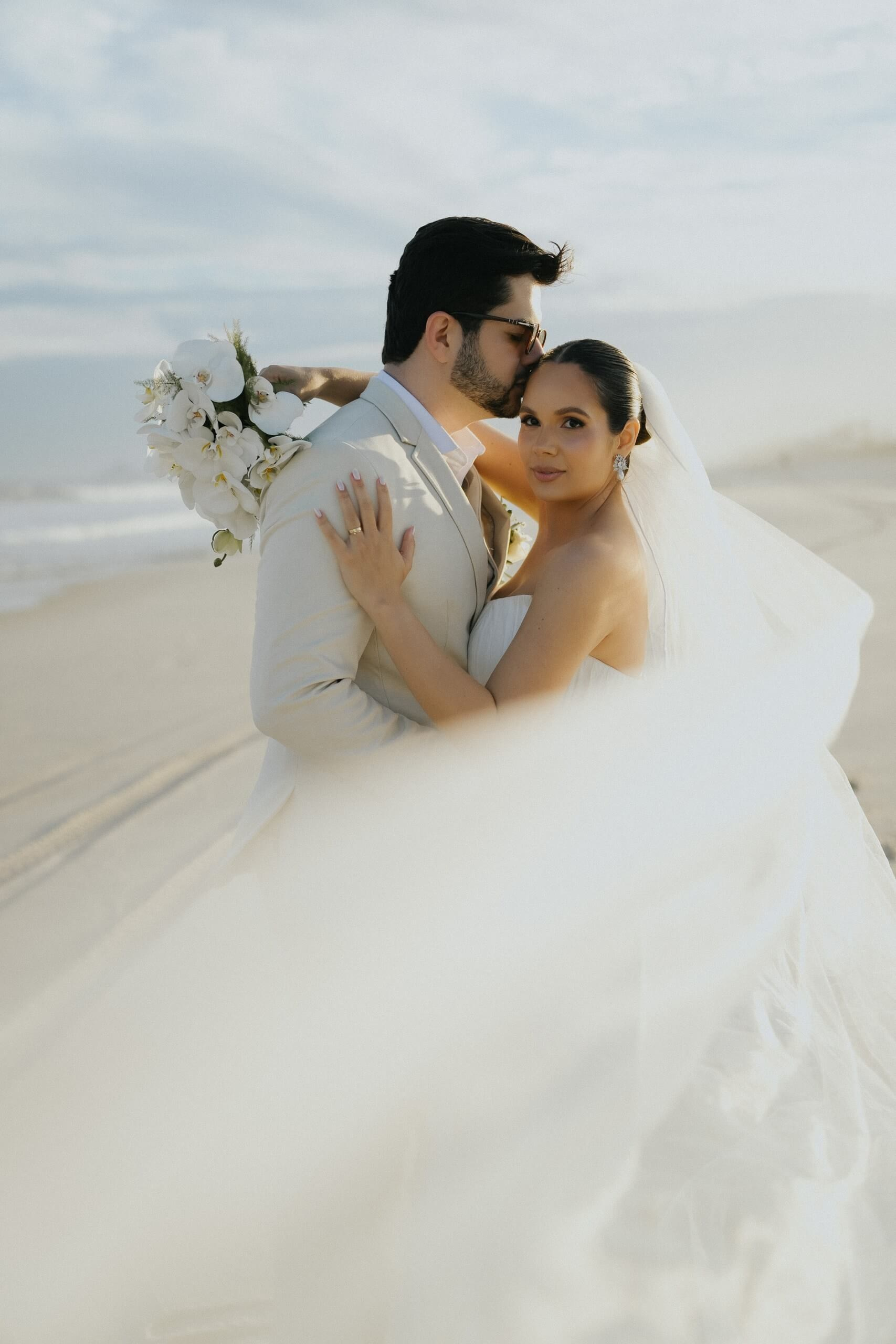 Elegant couple at beach destination wedding in Rio de Janeiro, romantic Brazil wedding photography.